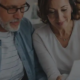 Mature husband and wife looking at insurance documents.